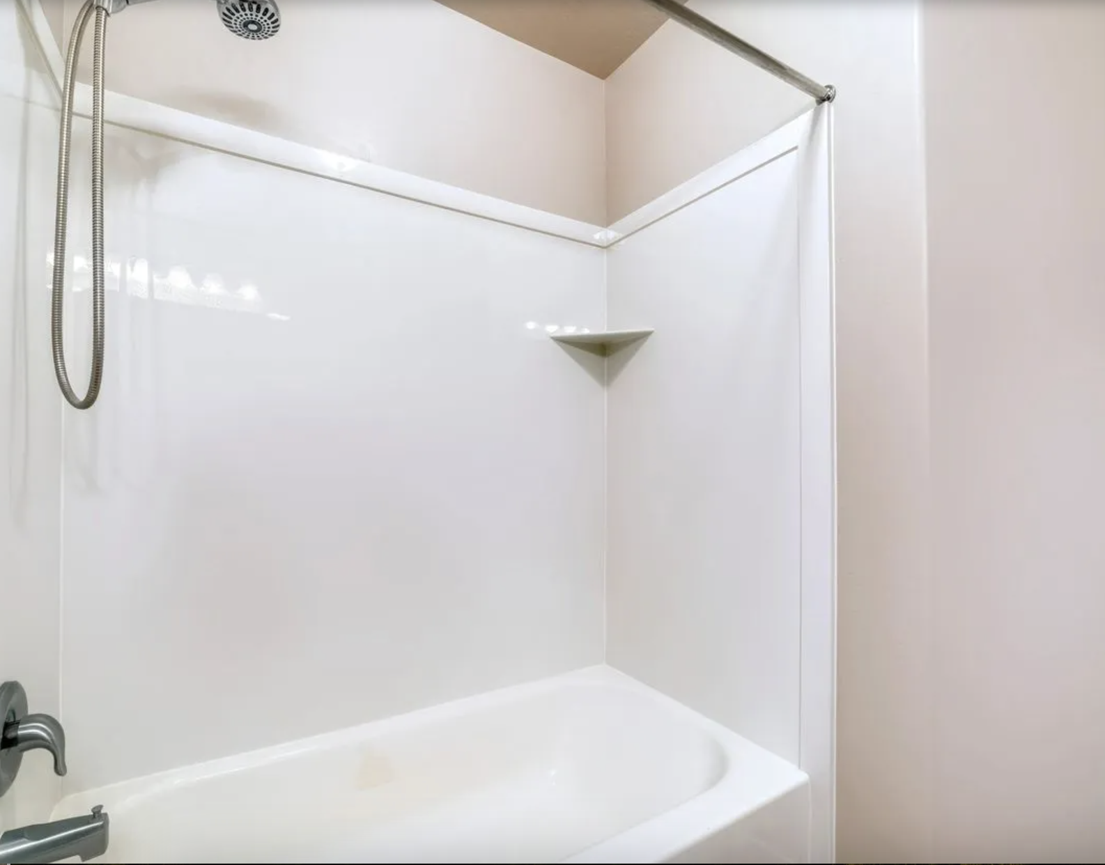 Refinished bathroom with subway tile shower surround